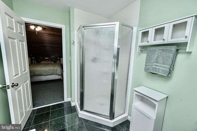 bathroom with tile patterned flooring and a shower with shower door