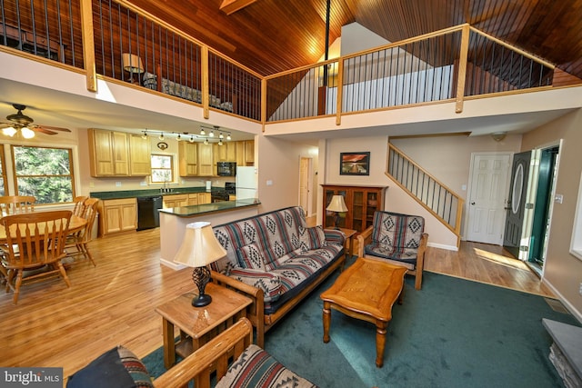 living room featuring light hardwood / wood-style floors, high vaulted ceiling, ceiling fan, and wood ceiling