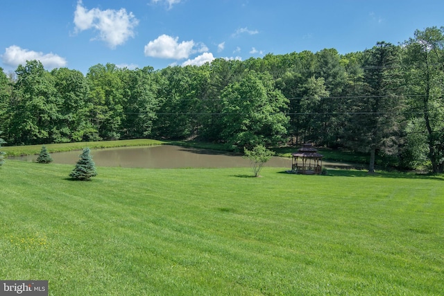 view of yard featuring a gazebo and a water view