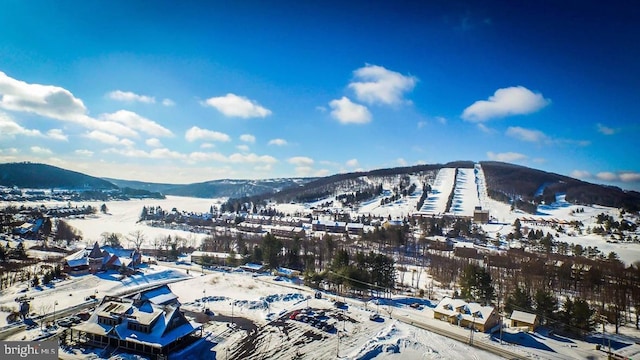 snowy aerial view with a mountain view