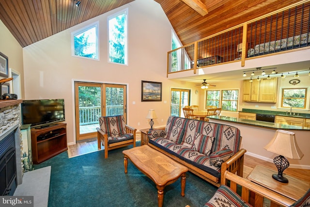 living room with sink, wood-type flooring, high vaulted ceiling, wooden ceiling, and a fireplace