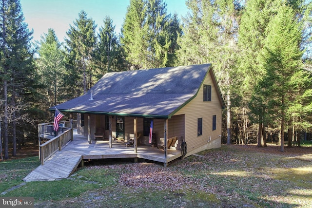 rear view of house featuring a deck