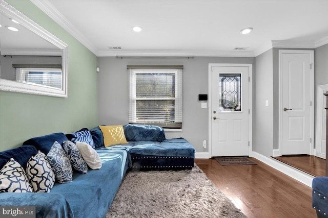 living room with dark hardwood / wood-style flooring and crown molding