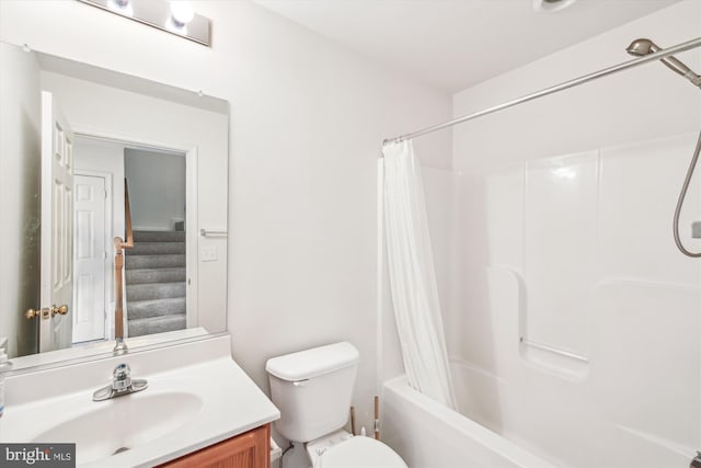 full bathroom featuring shower / bath combination with curtain, toilet, and vanity