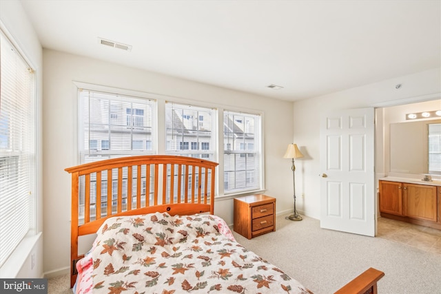 carpeted bedroom featuring ensuite bathroom