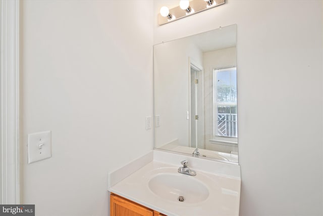 bathroom with plenty of natural light and vanity