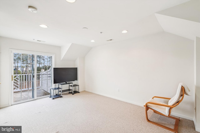 sitting room featuring carpet flooring and lofted ceiling