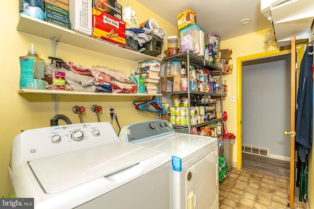 washroom with washer and dryer and light wood-type flooring