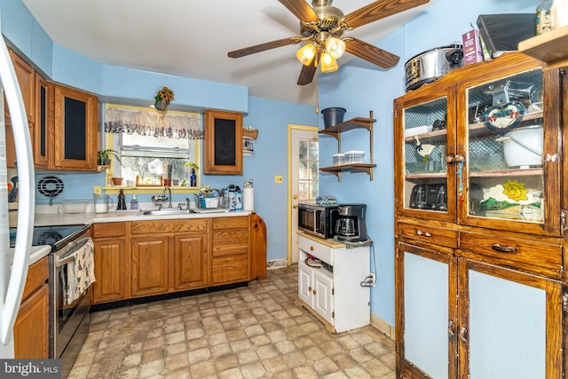 kitchen with a wealth of natural light, sink, ceiling fan, and stainless steel electric range