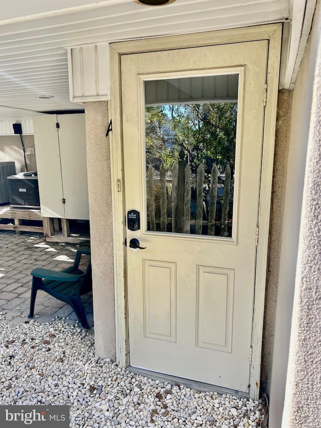 entrance to property featuring central AC unit