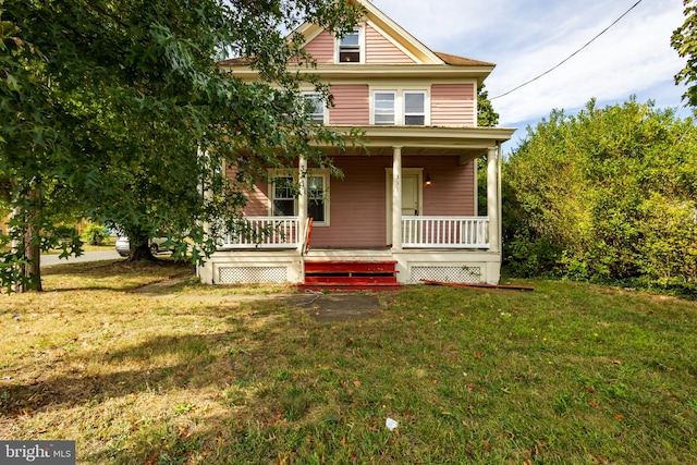 view of front of house featuring a front yard and covered porch