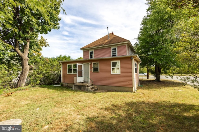 back of property featuring a lawn