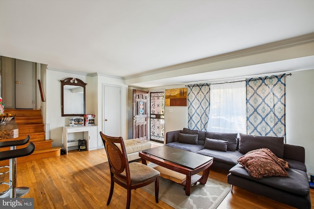 living room featuring light hardwood / wood-style flooring and ornamental molding