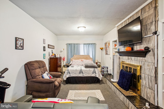 bedroom featuring a textured ceiling, carpet flooring, and a fireplace