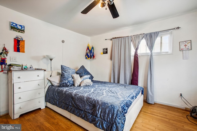 bedroom with ceiling fan and light hardwood / wood-style flooring