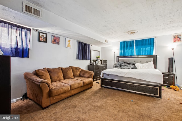 bedroom with carpet flooring and a textured ceiling