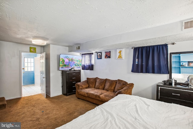 carpeted bedroom featuring a textured ceiling