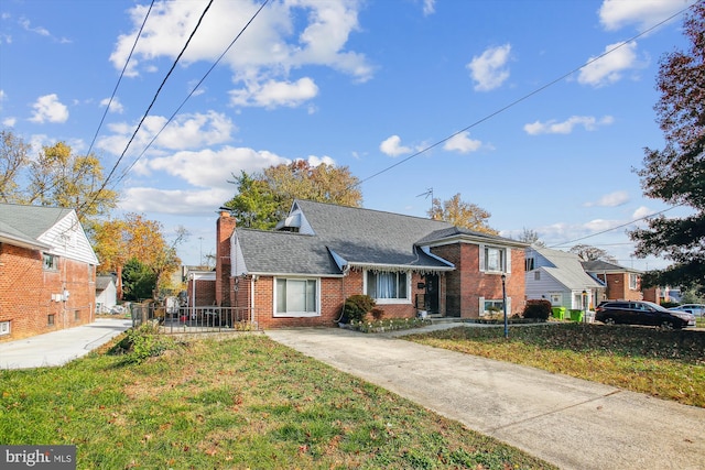 bungalow-style home with a front yard