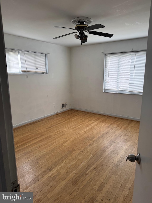 spare room with light hardwood / wood-style flooring and ceiling fan