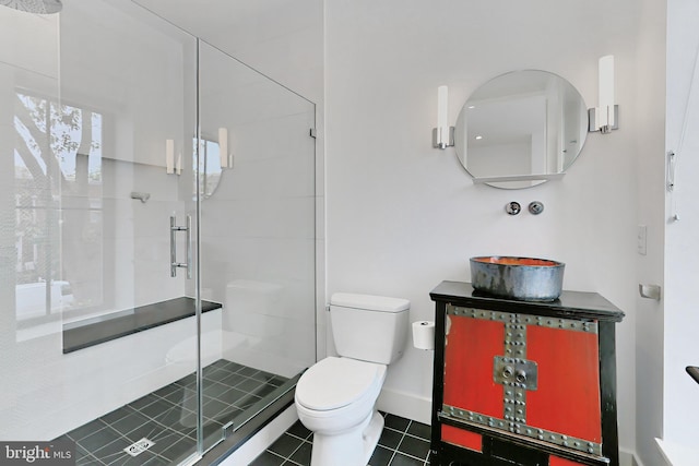 bathroom featuring tile patterned flooring, toilet, and walk in shower