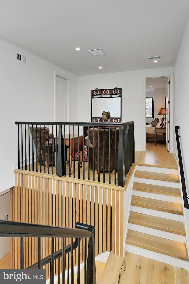 stairs with hardwood / wood-style floors