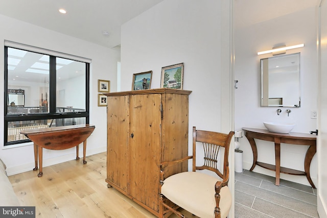 living area featuring light hardwood / wood-style flooring and sink