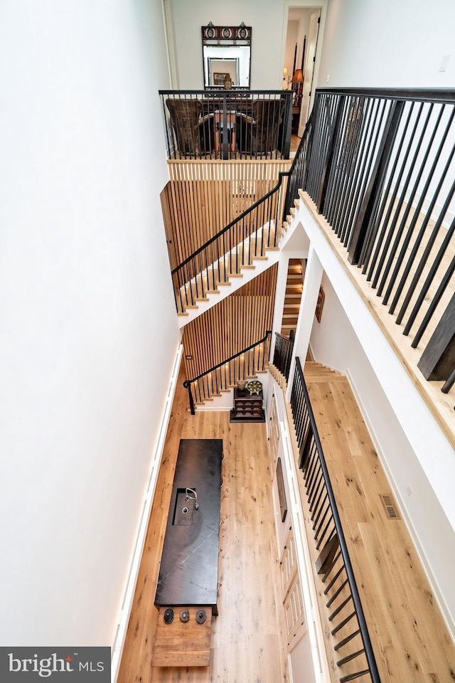 stairway with hardwood / wood-style floors