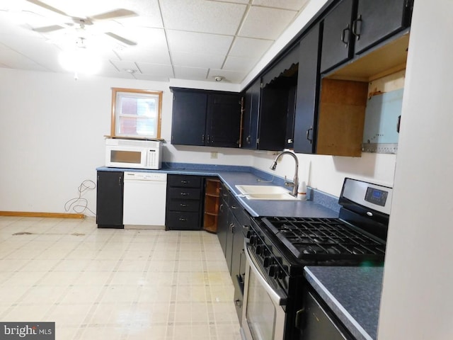 kitchen featuring a drop ceiling, sink, white appliances, and ceiling fan