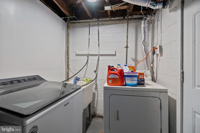 clothes washing area featuring separate washer and dryer