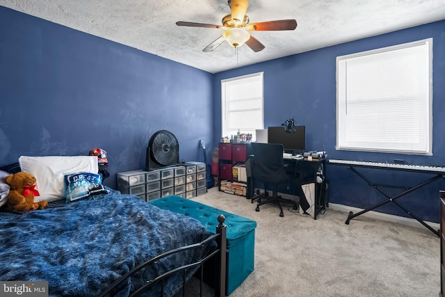 carpeted bedroom with a textured ceiling and ceiling fan