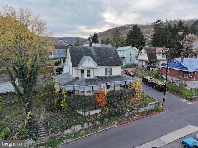 view of front of house with covered porch and a mountain view