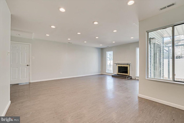 unfurnished living room featuring light hardwood / wood-style flooring