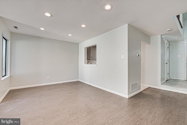 unfurnished room with light wood-type flooring