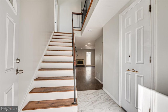 stairway with hardwood / wood-style flooring