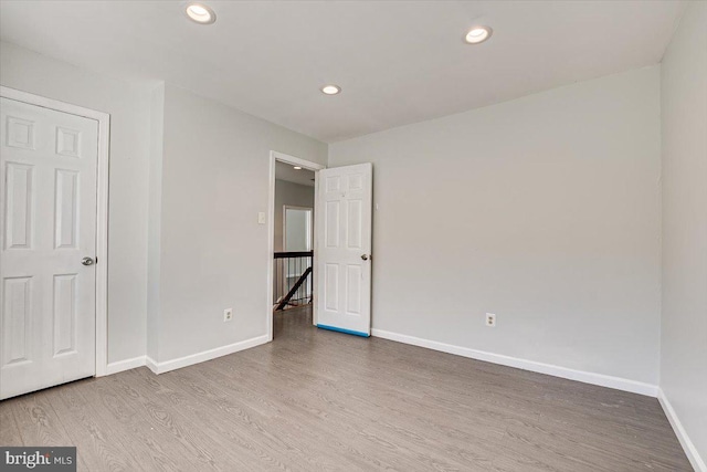 unfurnished bedroom with hardwood / wood-style flooring