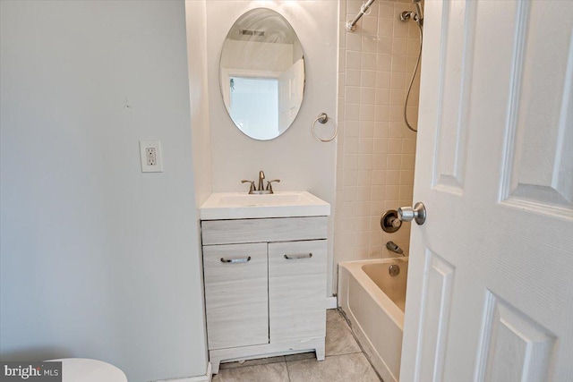 bathroom with tiled shower / bath, vanity, and tile patterned floors