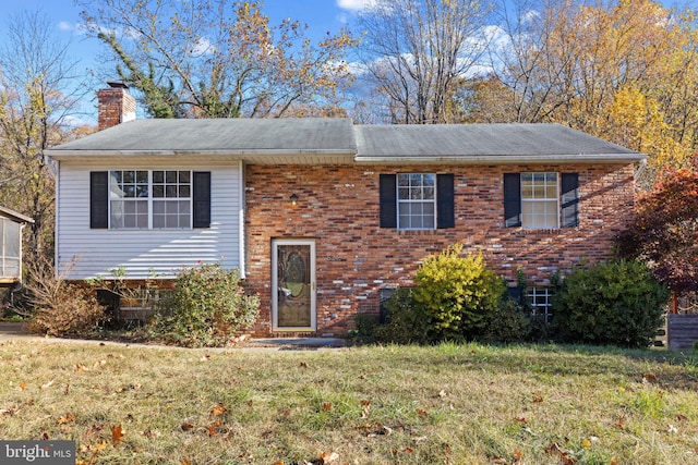 raised ranch featuring a front yard