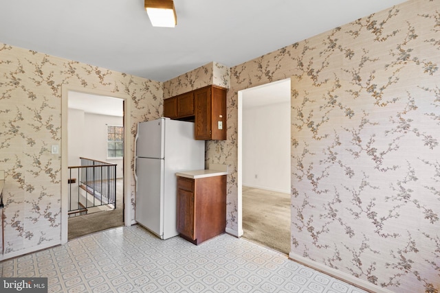 kitchen featuring white refrigerator and light carpet