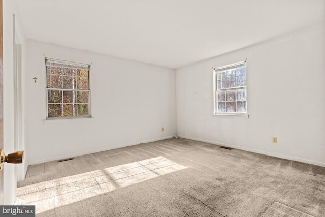 unfurnished room with light colored carpet