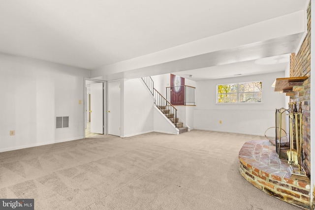 carpeted living room featuring a fireplace