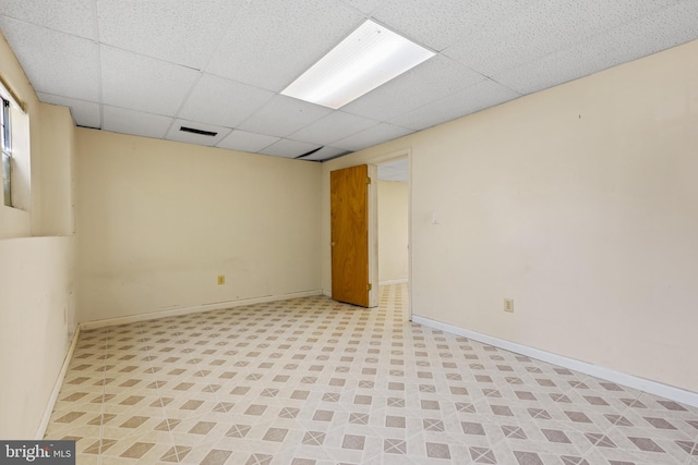 basement featuring a paneled ceiling