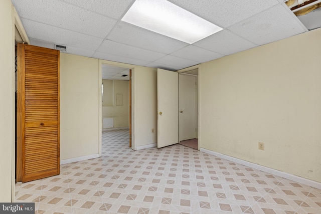 basement featuring a paneled ceiling