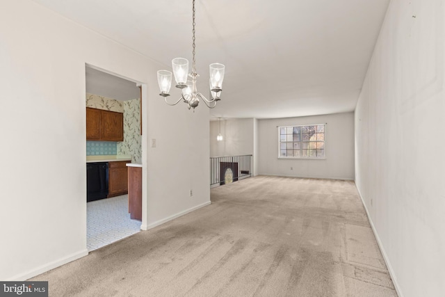 unfurnished living room with a notable chandelier and light colored carpet