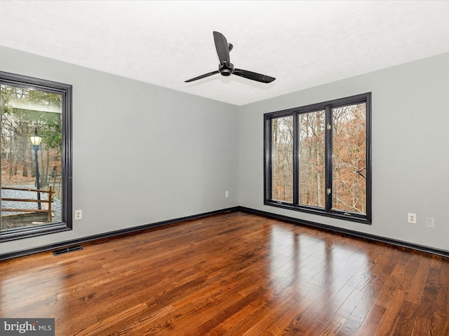 empty room with ceiling fan and hardwood / wood-style floors