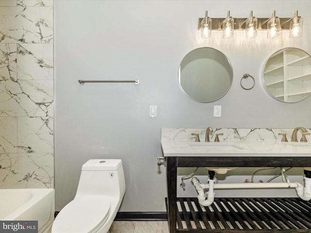 bathroom featuring toilet and sink