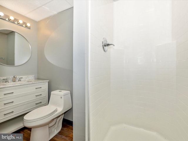 bathroom featuring hardwood / wood-style flooring, toilet, a shower, and vanity