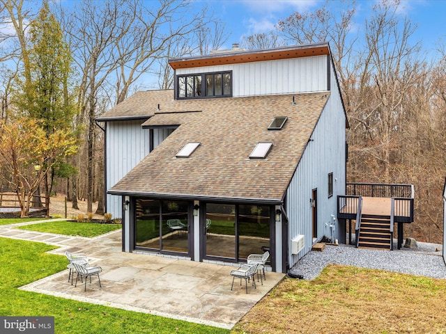 rear view of property with a yard, a patio, and a wooden deck