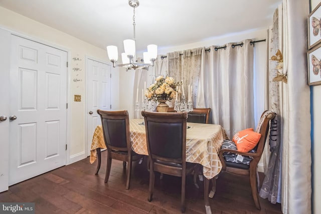 dining area featuring an inviting chandelier and dark hardwood / wood-style flooring