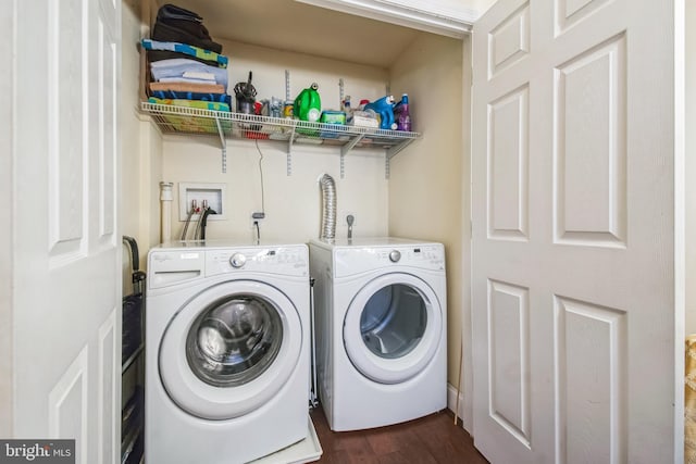 clothes washing area with washer and clothes dryer and dark hardwood / wood-style flooring