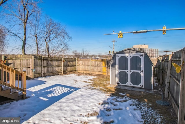 yard covered in snow with a shed